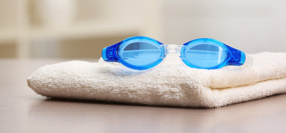  A pair of swim goggles on a towel