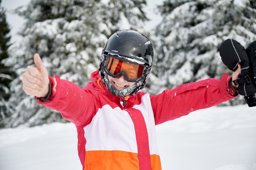 A boy with Ski goggles on snow