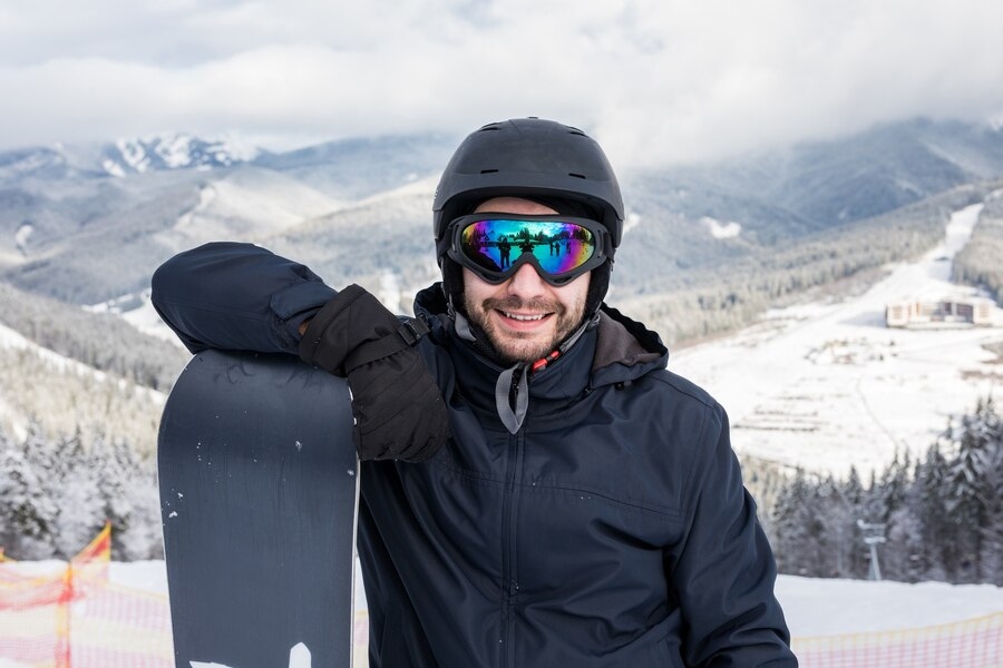 A men smiling wearing Ski goggles