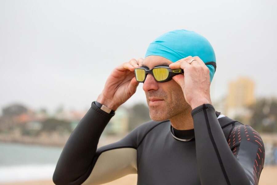 Person Adjusting his Swimming Goggles